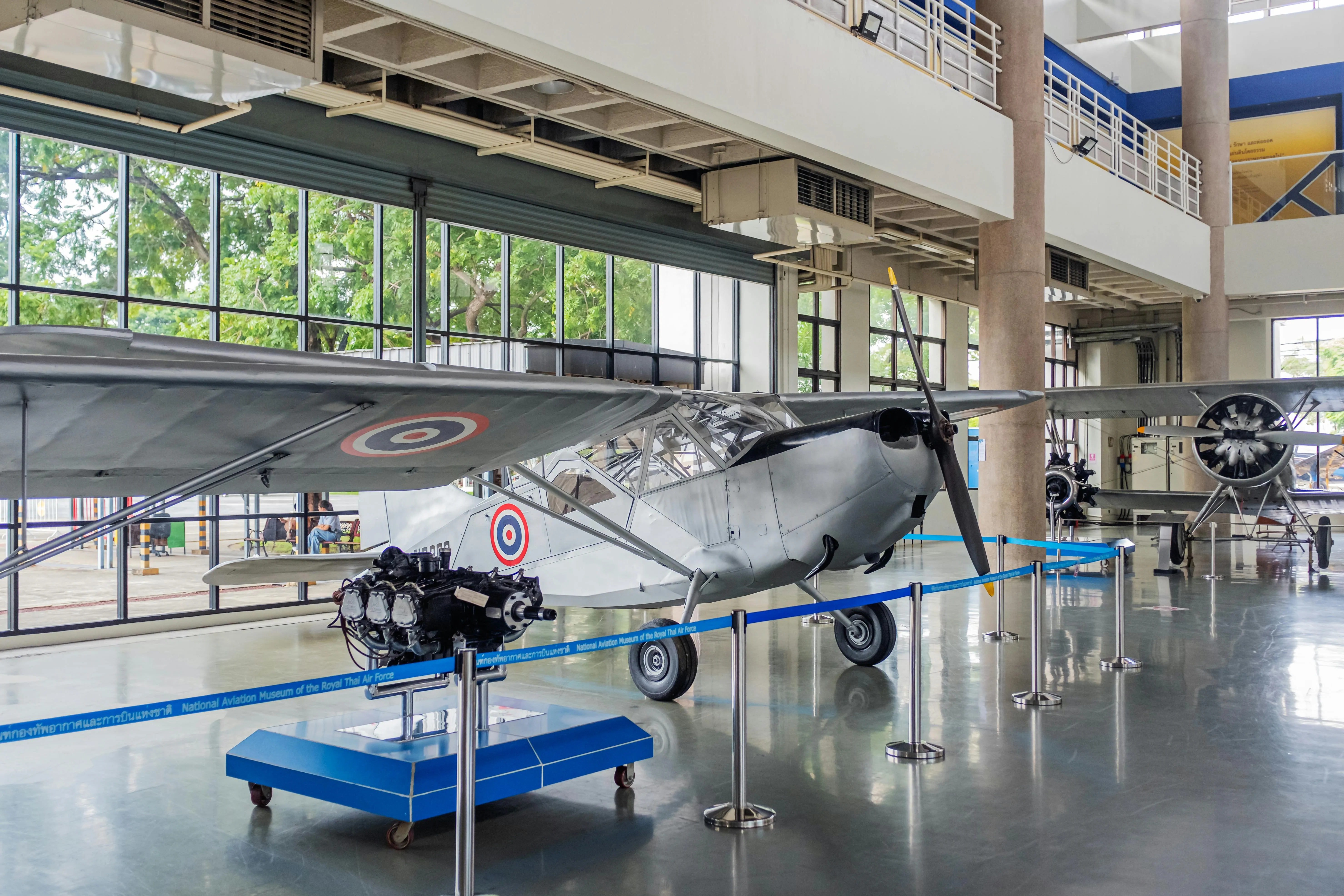 An aircraft hangar interior with a parked aircraft visible through the bay doors